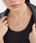 Bob Rollers Adolph yellow gold chain and yellow gold round pendant set with pavé diamonds on the edges